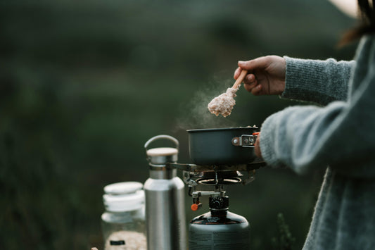 woman cooking at camp
