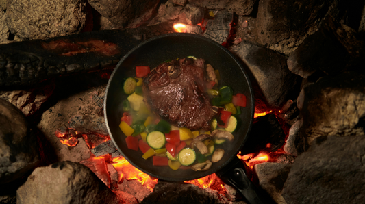 steak cooking over the fire